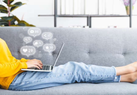 Woman using computer laptop with icon social media and social network. Online marketing concept
