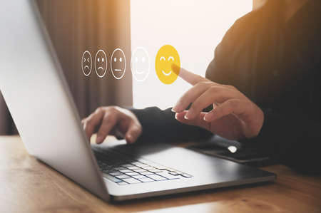 Customer service experience and business satisfaction survey. Male hand using computer laptop choose...