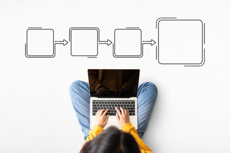 Top view of woman sitting on floor and using laptop with illustration business process and workflow automation with flowchartの写真素材
