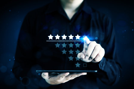 Businessman pointing five star symbol to increase rating of companyの写真素材