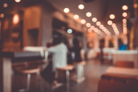 Blurred images of the coffee shop cafe interior background and lighting bokehの写真素材