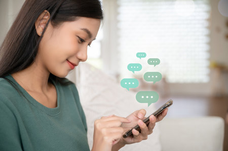 Woman using mobile smartphone. Online live chat chatting on application communication digital media website and social networkの写真素材