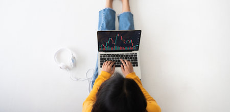 Investment financial stock market concept. Top view woman using computer laptop with application trading stock on screen deviceの写真素材