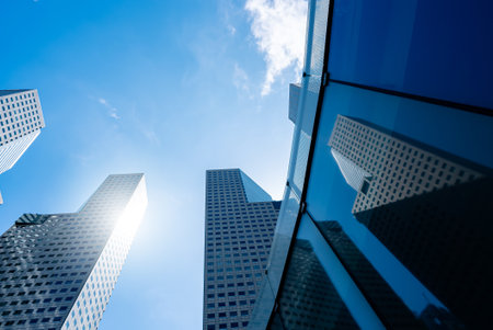 Office tall building. Low angle view of skyscrapers modern office building city in business center with blue skyの写真素材