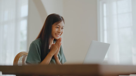 Excited asian female feeling euphoric celebrating online win success achievement result, young woman happy about good email news, motivated by great offer or new opportunity, passed exam, got a jobの写真素材