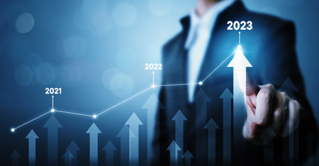 Businessman pointing arrow graph corporate future growth plan. Business development to success and growing growth year 2022 to 2023 conceptの写真素材