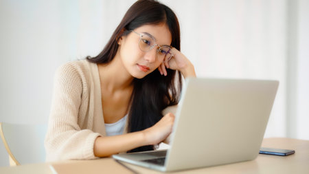 Young asian woman upset, frustrated by problem with work or relationships,  feeling despair and anxiety, loneliness, having psychological troubleの写真素材