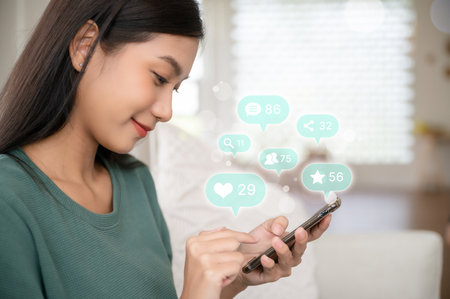 Woman hand using mobile smartphone with icon social media and social network. Online marketing conceptの写真素材