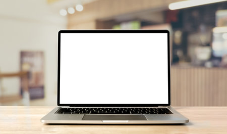 Laptop blank screen on wood table with coffee cafe background, mockup, template for your text, Clipping paths included for background and device screenの写真素材