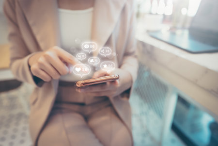 Woman hand using mobile smartphone with icon social media and social network. Online marketing conceptの写真素材