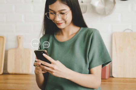 Woman using mobile smartphone. Online live chat chatting on application communication digital media website and social networkの写真素材