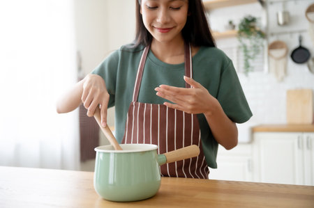 Young beauty asian woman cooking in kitchen room at homeの写真素材