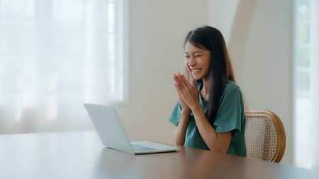 Excited asian female feeling euphoric celebrating online win success achievement result, young woman happy about good email news, motivated by great offer or new opportunity, passed exam, got a jobの写真素材