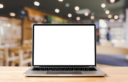 Laptop blank screen on wood table with coffee cafe background, mockup, template for your text, Clipping paths included for background and device screenの写真素材