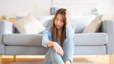 Young asian woman upset , sadness and frustrated by problem with work or relationships. Feeling despair and anxiety, loneliness, having psychological troubleの写真素材