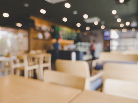 Blurred images of the coffee shop cafe interior background and lighting bokehの写真素材