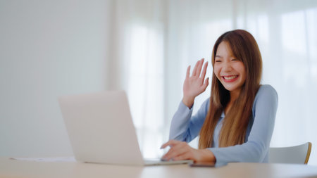 Young asian woman working on computer laptop at house. Work at home, Video conference, Video call, Student learning online class, meeting conferenceの写真素材