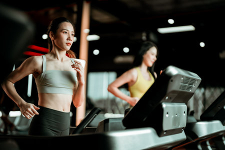 Young Asian Woman Running on Treadmill - Fitness Gym Exercise