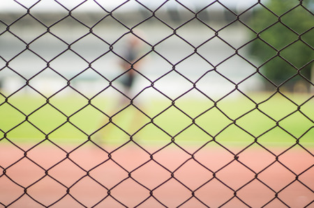 Solid metallic mesh fence closeup Blur Stadiumの写真素材