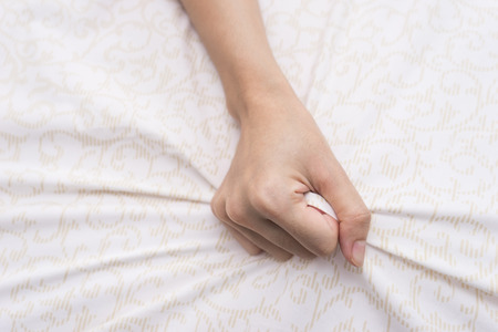 hand grasp bed sheet