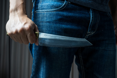 Man with a knife in a hand , in dark toneの写真素材