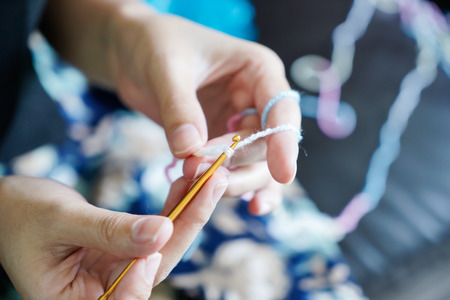 Woman hands crocheting with hookの写真素材