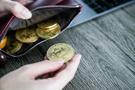 Virtual currency wallet gold bitcoin. bitcoin laptop wallet. Bitcoin in hand.