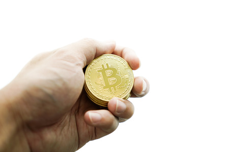 hand with golden bitcoin coin on the white background.