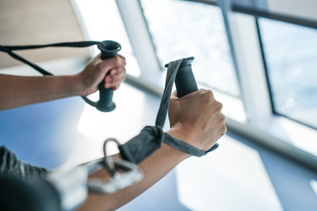 The hand is pulling the fitness machine in the gym.の写真素材