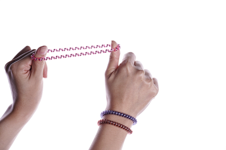 Hand holding or playing elastic hair band