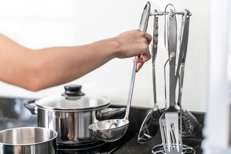 hand holding a ladle or kitchen spoonの写真素材