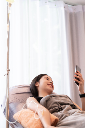 women have needle injection vitamins and minerals directly into bloodstream in clinicの写真素材