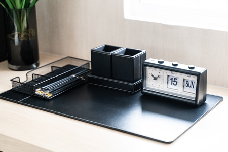 black clock on work table at homeの写真素材