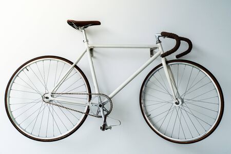 retro bicycle hanging on the white wallの写真素材
