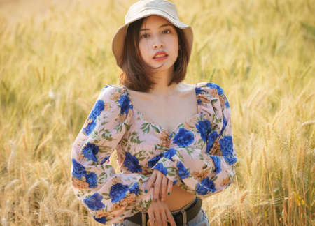 Woman enjoying nature in a farm fieldの写真素材