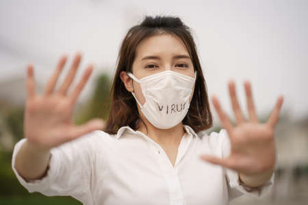 Shocked woman wearing protective mask corona virus (covid-19) text written