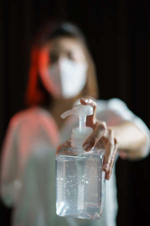 Woman sharing alcohol gel or sanitizer gel for washing hands, corona virus or Covid-19 protection.の写真素材
