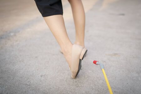 Worker with spray the cleaning sanitize chemical to disinfect COVID-19 virus pathogen on shoes.の写真素材