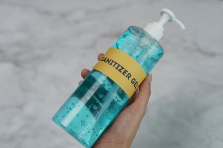 Hands with sanitizer gel pump dispenser. Transparent sanitizer in pump bottle, for killing germs, bacteria and virus.の写真素材