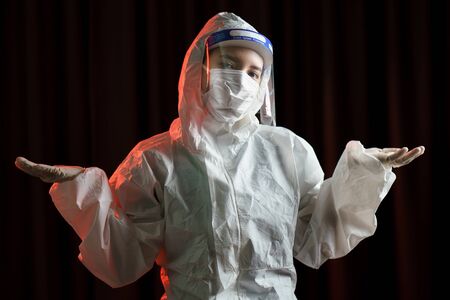 Woman wearing gloves, biohazard protective suit, face shield and mask. For corona virus or Covid-19...