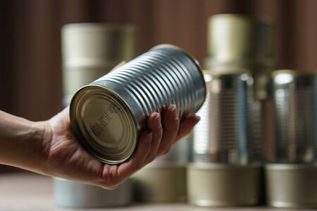 Woman hand with group of Aluminium canned food.の写真素材