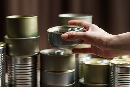 Woman hand with group of Aluminium canned food.の写真素材