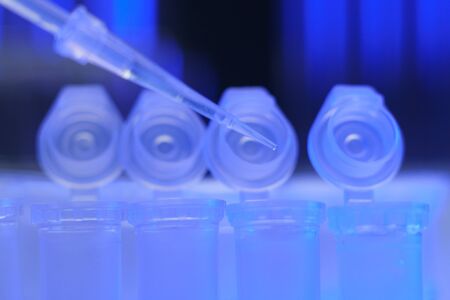 Medical equipment. Pipette adding fluid to one of several test tubes .