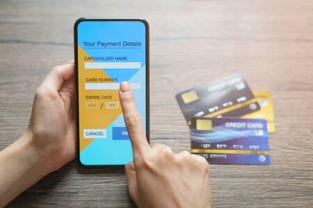 Online shopping concept : woman hands holding cradit card and using credit card online shopping....