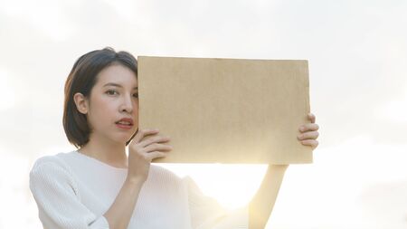 Woman holding a blank banner to put the text at protesting.の写真素材
