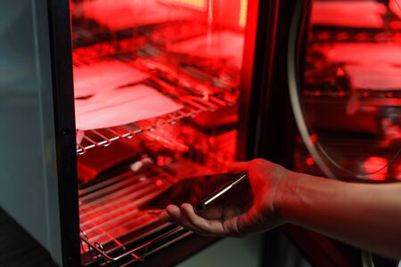 UV light sterilization of mobile phone and  face mask to disinfection. COVID-19 prevention concept....