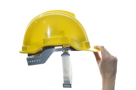 Woman hand holding  yellow safety helmet isolated on white background.