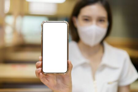 mobile phone blank display with Woman wearing face maskの写真素材