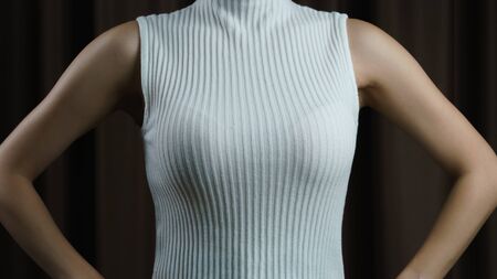 The women with white sleeveless shirt on black background.の写真素材