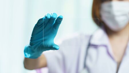 Doctor hand hold transparent tablet display showing empty in screen.の写真素材